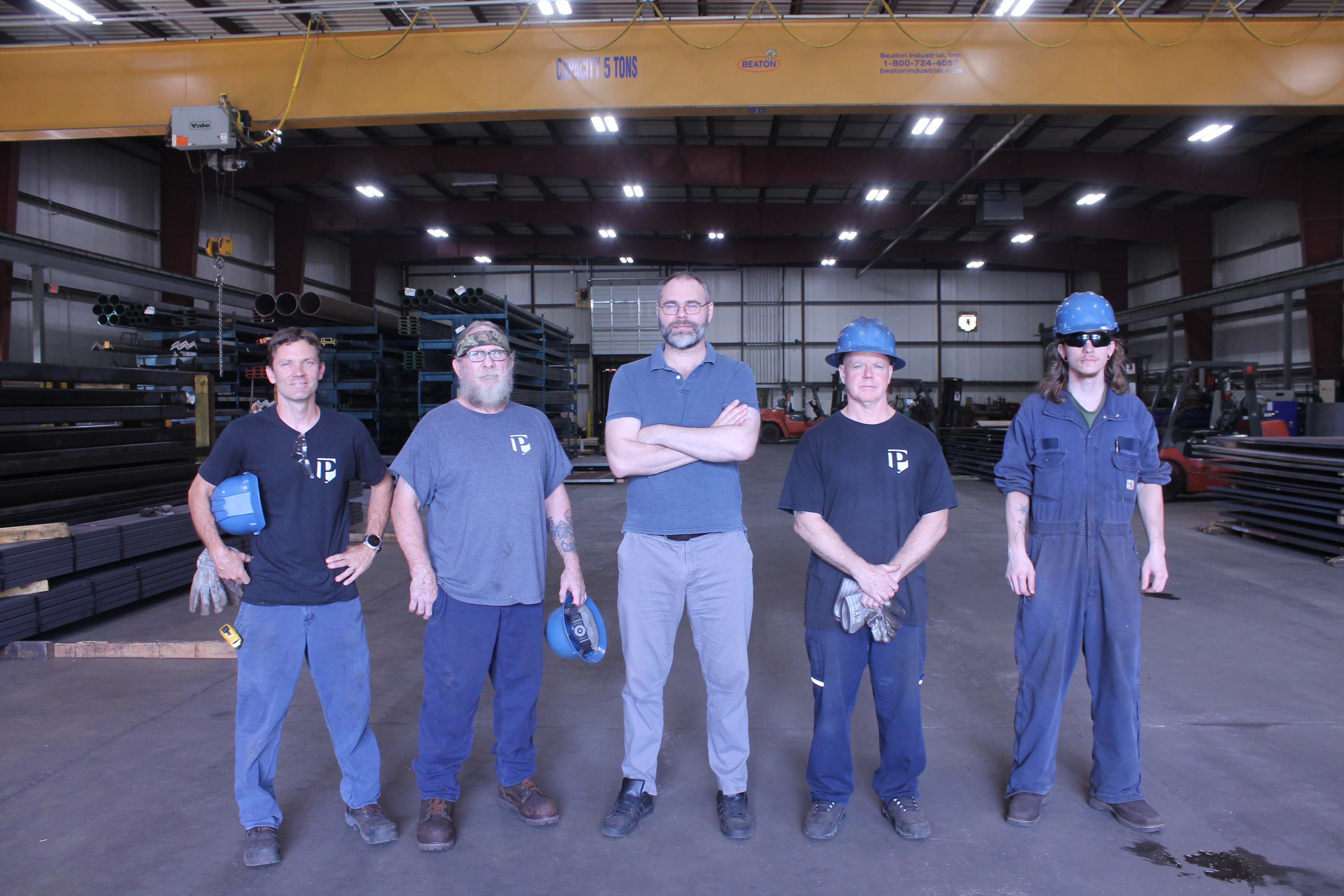 Pacemaker Steel processing team standing in the warehouse facility